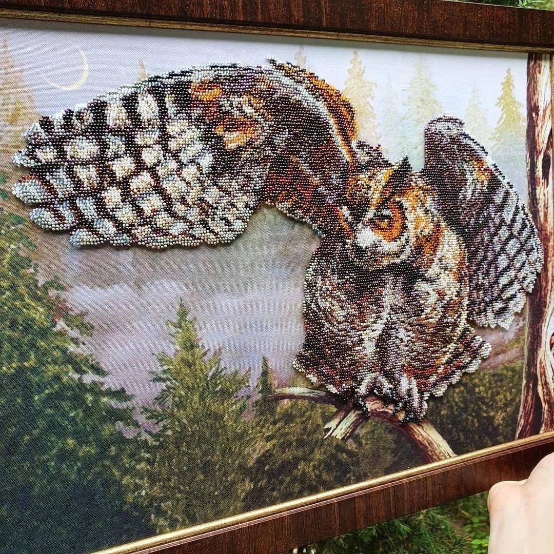 Close-up of intricate beadwork detailing the feathers of the Wise Bird