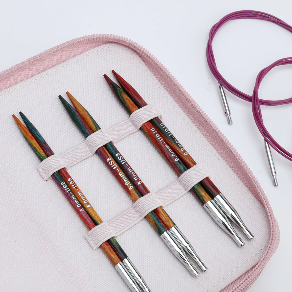 KnitPro Symfonie 2 Normal interchangeable needle set, 13 cm, Starter - Set of colorful knitting needles in a pink case on a white background