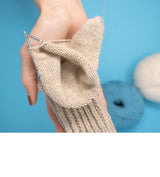 addiSockwonder Lace circular knitting needle 25cm - 710-7 - Hand knitting a beige sock with yarn on a blue background